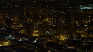 AX67_0106 - 4.8K aerial stock footage view of flying by Brooklyn projects at night, New York