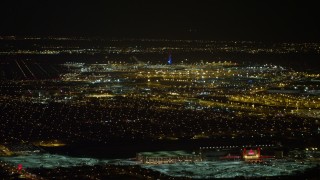 AX67_0108 - 4.8K aerial stock footage view of flying by John F. Kennedy International Airport at night, New York