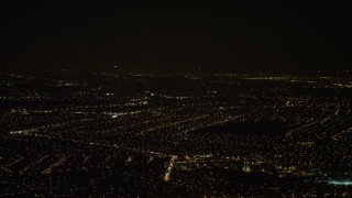 AX67_0109 - 4.8K aerial stock footage view of tracking a jet over Queens at night, New York