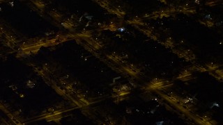 AX67_0111 - 4.8K aerial stock footage view of flying by residential neighborhoods in Queens at night, New York