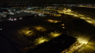 AX67_0121 - 4.8K aerial stock footage view orbit Republic Airport control tower, pan and approach hangars at night, Long Island, New York