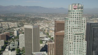 AX68_024 - 4.8K stock footage aerial video approach the top of US Bank Tower in Downtown Los Angeles, California, and reveal City Hall