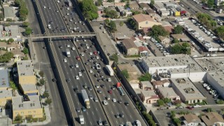 AX68_034 - 4.8K aerial stock footage of traffic on Interstate 5 through East Los Angeles, California
