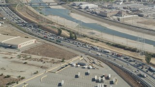 AX68_036 - 4.8K aerial stock footage of heavy traffic on a bend in I-710 by the Los Angeles River in Vernon, Los Angeles, California