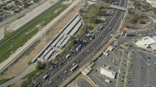 AX68_041 - 4.8K aerial stock footage of reverse bird's eye view of traffic on Interstate 710 in Bell Gardens, Los Angeles, California