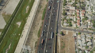 AX68_042 - 4.8K aerial stock footage of reverse bird's eye view of light traffic on Interstate 710 through Bell Gardens, Los Angeles, California