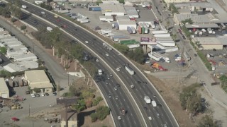 AX68_044 - 4.8K aerial stock footage of light traffic on I-710 crossing the Los Angeles River in South Gate, Los Angeles, California