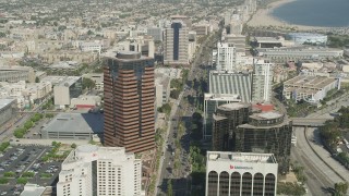AX68_055 - 4.8K aerial stock footage follow Ocean Boulevard between office buildings in Downtown Long Beach, California