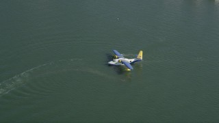 AX68_063 - 4.8K aerial stock footage of seaplane waiting for takeoff from San Pedro Bay, Long Beach, California