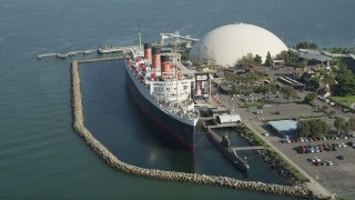 AX68_064 - 4.8K aerial stock footage tilt to reveal the Queen Mary Docked in Long Beach, California