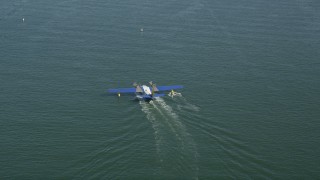 AX68_072 - 4.8K aerial stock footage of tracking a seaplane on San Pedro Bay, Long Beach, California
