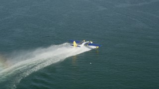 AX68_075 - 4.8K aerial stock footage of tracking a seaplane racing across San Pedro Bay for takeoff, Long Beach, California