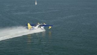 AX68_076 - 4.8K aerial stock footage track seaplane speeding across San Pedro Bay in Long Beach, California