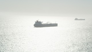 AX68_086 - 4.8K aerial stock footage of a pair of oil tankers sailing the Pacific Ocean