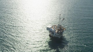 AX68_101 - 4.8K aerial stock footage orbit of an oil platform off the coast of California near Long Beach
