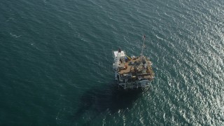 AX68_102 - 4.8K aerial stock footage of bird's eye view of an oceanic oil platform off the California Coast near Long Beach