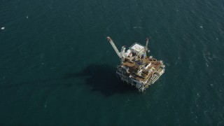 AX68_103 - 4.8K aerial stock footage of bird's eye of an oil drilling platform near the California Coast, Long Beach