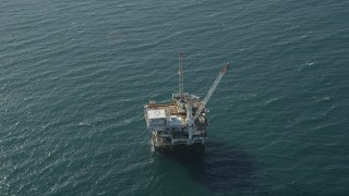AX68_106 - 4.8K aerial stock footage of flyby an oil platform just off the California Coast, Long Beach
