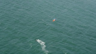 AX68_118 - 4.8K aerial stock footage track a kite surfer in San Pedro Bay, Long Beach, California
