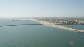 AX68_121 - 4.8K aerial stock footage approach the breakwater, pier, beach and coastal neighborhoods in Seal Beach, California