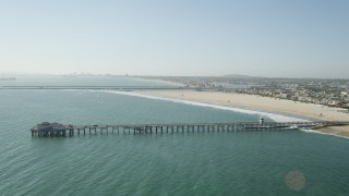 AX68_123 - 4.8K aerial stock footage of Seal Beach Municipal Pier and the beach by coastal homes in Seal Beach, California