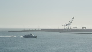 AX68_132 - 4.8K aerial stock footage of a ferry cruising across San Pedro Bay in Long Beach, California