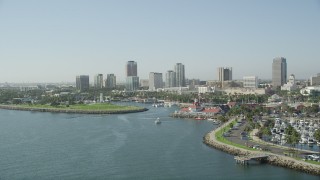 AX68_135 - 4.8K aerial stock footage pass Shoreline Marina and village to approach Rainbow Harbor and Downtown Long Beach skyline, California