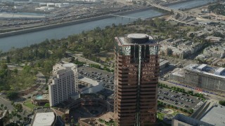 AX68_138 - 4.8K aerial stock footage approach and fly over a modern office building in Downtown Long Beach, California