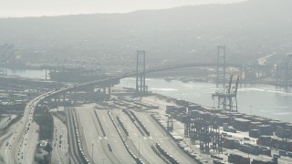 AX68_145 - 4.8K aerial stock footage of approaching the Vincent Thomas Bridge at the Port of Los Angeles, California