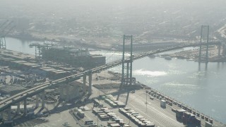 AX68_147 - 4.8K aerial stock footage of light traffic crossing the Vincent Thomas Bridge in Port of Los Angeles, California