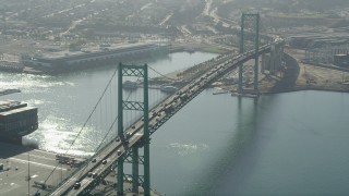 AX68_148 - 4.8K aerial stock footage approach cars crossing the Vincent Thomas Bridge in the Port of Los Angeles, California