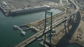 AX68_150 - 4.8K aerial stock footage of light traffic crossing Vincent Thomas Bridge at the Port of Los Angeles in California