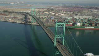 AX68_151 - 4.8K aerial stock footage of cars and trucks crossing the Vincent Thomas Bridge at the Port of Los Angeles, California
