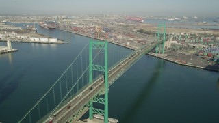 AX68_156 - 4.8K aerial stock footage approach the Vincent Thomas Bridge at the Port of Los Angeles, California and tilt to traffic