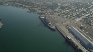 AX68_158 - 4.8K aerial stock footage approach Battleship USS Iowa at the Port of Los Angeles, California