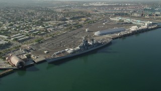 AX68_160 - 4.8K aerial stock footage reverse view of the USS Iowa and the Port of Los Angeles, California