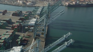 AX68_165 - 4.8K aerial stock footage fly over cargo cranes at the Port of Los Angeles, California