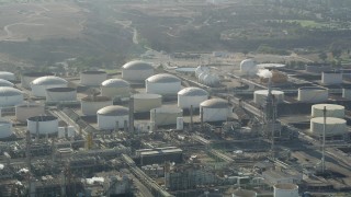 AX68_172 - 4.8K aerial stock footage of passing tanks at the Los Angeles Refinery Wilmington Plant in San Pedro, California