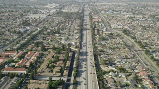 AX68_176 - 4.8K aerial stock footage fly over light traffic on I-110 through suburbs in Carson, California
