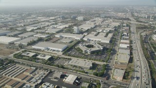AX68_181 - 4.8K aerial stock footage of office buildings and several warehouses by I-110 in Torrance, California