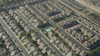 AX68_185 - 4.8K stock footage aerial video tilt to a bird's eye view of tract homes in Gardena, California