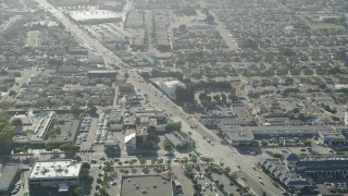 AX68_187 - 4.8K aerial stock footage of Redondo Beach Boulevard with homes and strip malls in Gardena, California