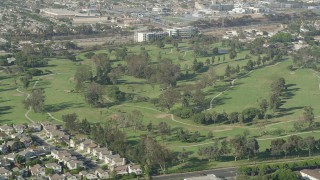 AX68_190 - 4.8K aerial stock footage of golfers and carts at Chester Washington Golf Course in Hawthorne, California