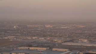 AX69_010 - 4.8K aerial stock footage track an airliner on approach to LAX at sunset, Los Angeles, California