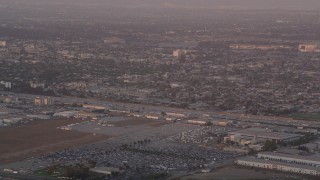 AX69_013 - 4.8K aerial stock footage of tracking an airliner approaching LAX at sunset for a landing, Los Angeles, California