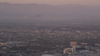 AX69_015 - 4.8K aerial stock footage track airliner on approach to LAX at sunset, Los Angeles, California