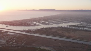 AX69_019 - 4.8K aerial stock footage of sunset at Marina Del Rey coastal neighborhoods, California