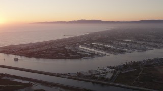AX69_020 - 4.8K aerial stock footage approach coastal community of Marina Del Rey at sunset, California