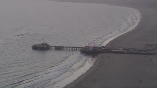 AX69_029 - 4.8K aerial stock footage of Santa Monica Pier at sunset with the Pacific Wheel lit up, California