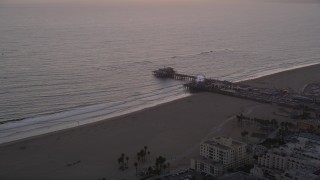 AX69_032 - 4.8K aerial stock footage of approaching Santa Monica Pier and Pacific Wheel at sunset, California